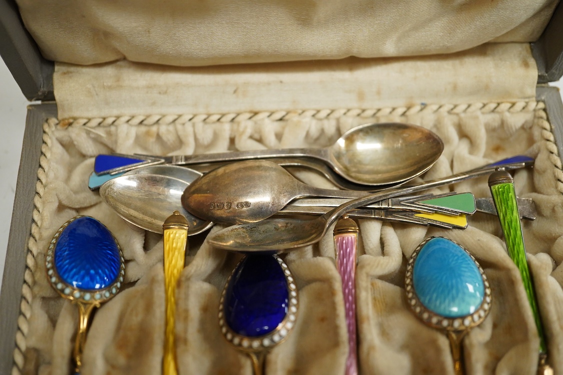 A cased set of silver Norwegian gilt 925 and polychrome enamelled coffee spoons(a.f.), 93mm, together with a set of six George V silver coffee spoons, with enamelled terminals, Deakin & Francis, Birmingham, 1933.